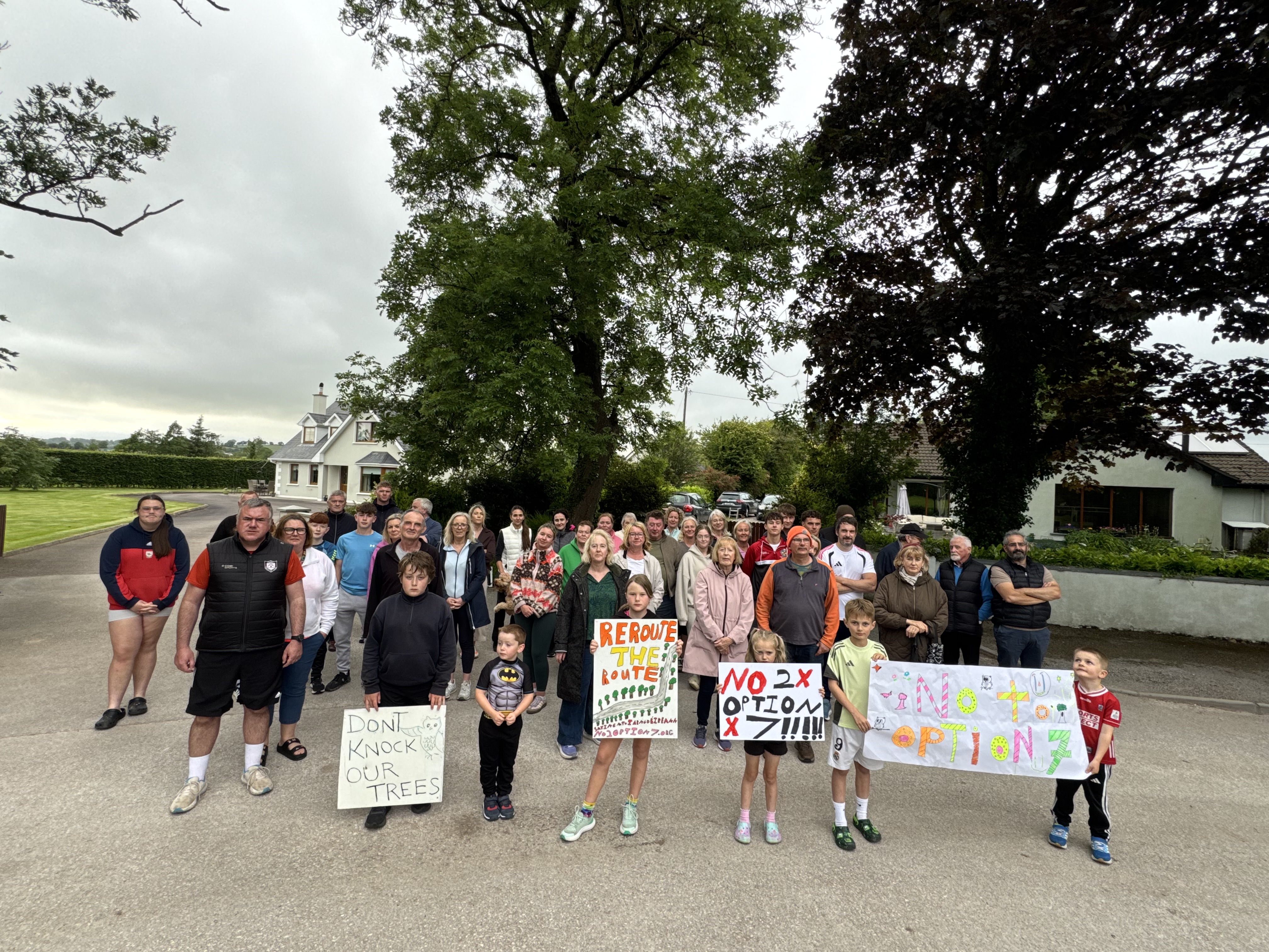 Large group of residents at Cotter's Gate with handmade signs