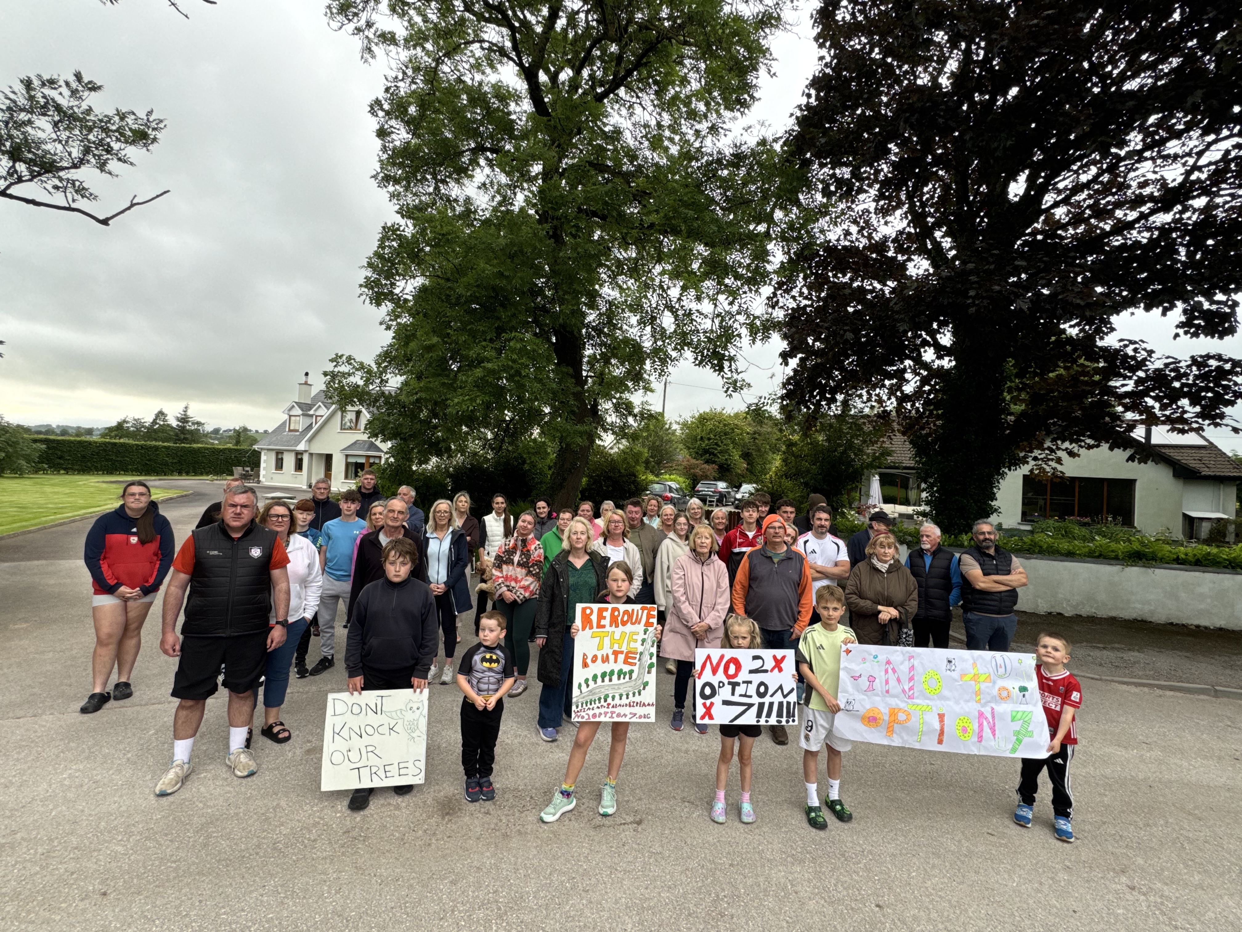 Residents at Cotter's Gate with handmade signs
