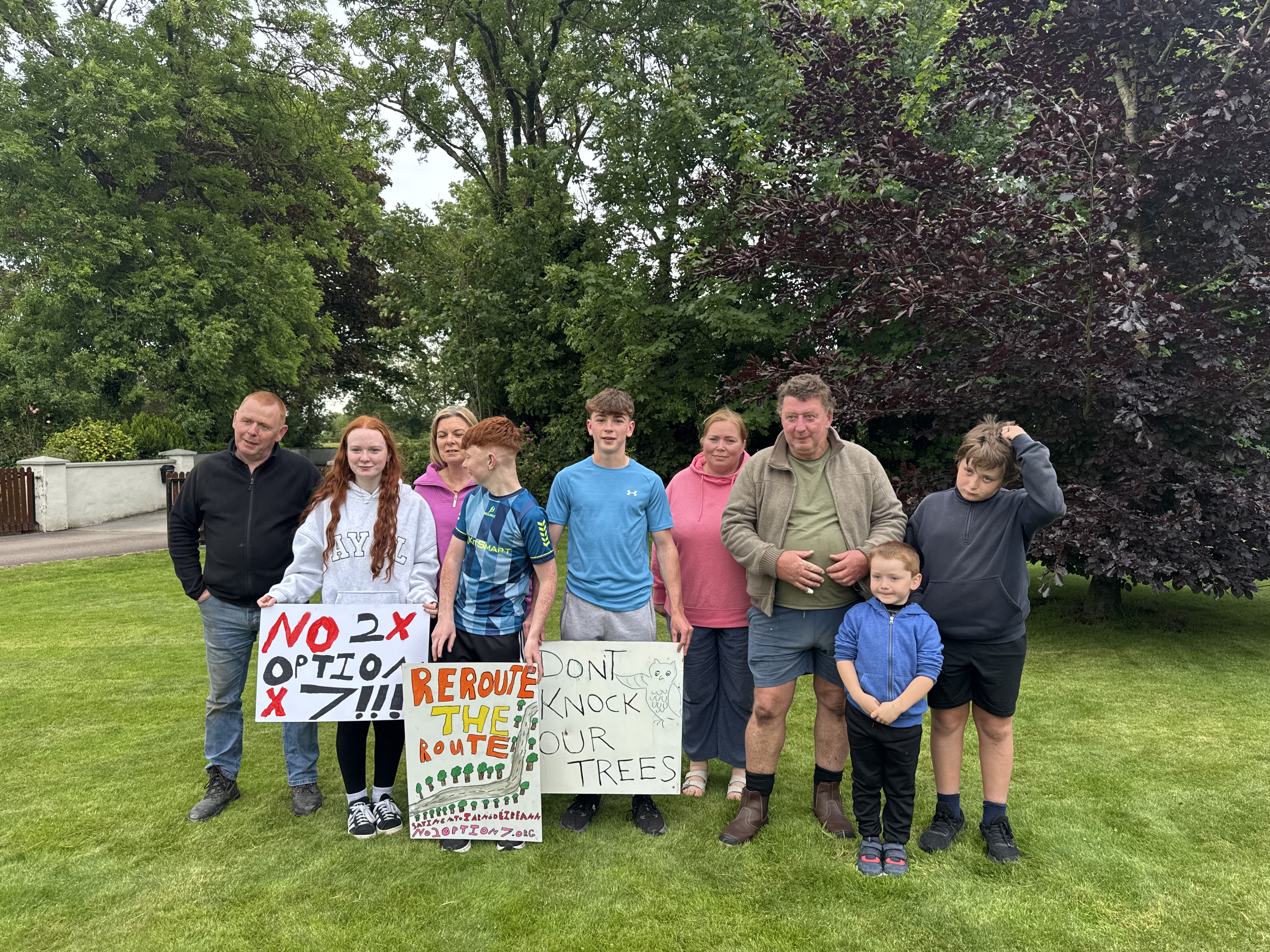 Family group on the lawn with protest signs