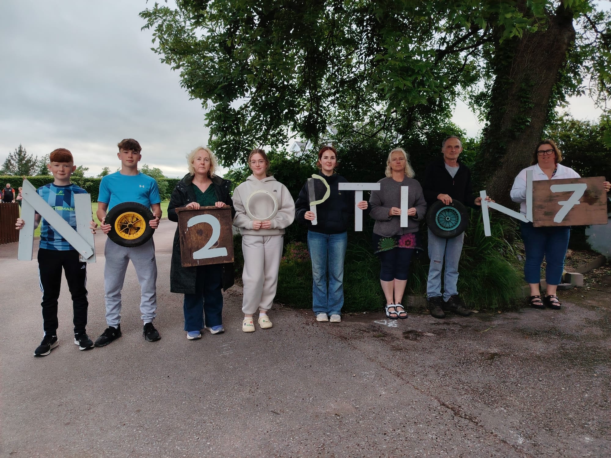 Residents holding letters spelling No 2 Option 7